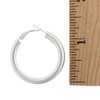 Italian 5mm round hoop earring with Omega back size with ruler.   Italian 5mm round hoop earring with Omega back size with ruler.