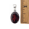 Red Garnet oval sterling silver pendant with a ruler. 