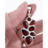 Multi-stone red Garnet large sterling silver pendant  in my hand. 