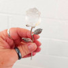 Clear Quartz stone rose on silver stem in my hand. 