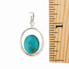 Oval Turquoise double framed sterling silver pendant with a ruler. 