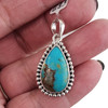 Teardrop-shaped blue Turquoise sterling silver pendant in my hand. 