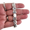 Square elastic alloy silver tone beaded bracelet in my hand. 