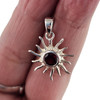 Garnet sterling silver sun pendant in my hand. 