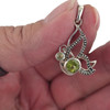 Peridot sterling silver pendant in my hand. 
