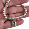 Gray Swarovski crystal elastic silver-plated bracelet in my hand. 
