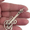Sterling silver 2" guitar pendant backside in my hand. 
