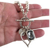 Silver-plated gray Swarovski crystal heart toggle necklace in my hand. 