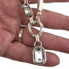 Silver-plated crystal pendant necklace in my hand. 