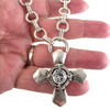Iron cross clear Swarovski crystal silver-plated necklace in my hand. 
