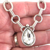 Clear teardrop crystal chain link necklace in my hand. 