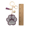 Pink paw keychain with rhinestones with a ruler. 