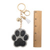 Silver and black rhinestone paw keychain with a ruler. 