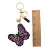 Pink butterfly rhinestone keychain with a ruler. 