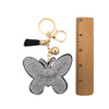 Silver rhinestone butterfly keychain with a ruler. 