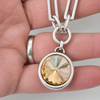 Golden champagne crystal paper clip necklace in my hand. 