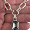 Gray Swarovski crystal chain necklace in my hand. 