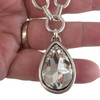 Large teardrop crystal silver-plated necklace in my hand. 