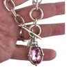 Pink crystal silver-plated necklace in my hand. 