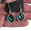 Blue crystal dangle earrings in my hand. 