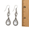 Two clear crystal dangle earrings with a ruler. 