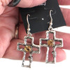 Champagne crystal cross dangle earrings in my hand. 