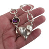 Silver-plated heart chain necklace with pink crystal in my hand.