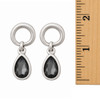 Gray teardrop circle stud earrings with a ruler. 
