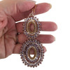 Large dangle lavender and taupe colored beaded earrings in my hand. 