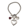Silver-plated braided chain toggle bracelet with a textured open heart, faceted deep red stone, and Pacific Northwest round charm on a white background.