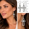 Silver-plated open cross dangle earrings with sparkling clear crystals shown on model with close-up detail and 2-inch length measurement.