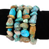 Extra large turquoise nugget stretch bracelets displayed on black velvet, featuring chunky polished stones in shades of blue, green, and earthy brown.