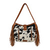 Back view of Myra Bag Loyal West Desert Trail Medium Shoulder Bag featuring genuine black and white hair-on calfskin, two vertical zippered pockets, brown leather trim, floral tooled leather accents, and long side fringe.