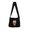 Black sling bag with colorful Day of the Dead skull on front of bag. 