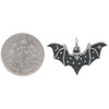 Small sterling silver bat charm pendant shown next to dime.  