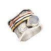 Side view of wide sterling silver Moonstone spinner mediation ring. 