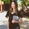 BED|STU CLEO Crossbody Purse with model holding as a clutch. 