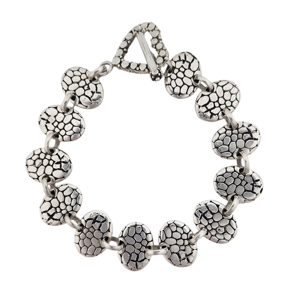 Oval sterling silver link bracelet with heart toggle clasp. 