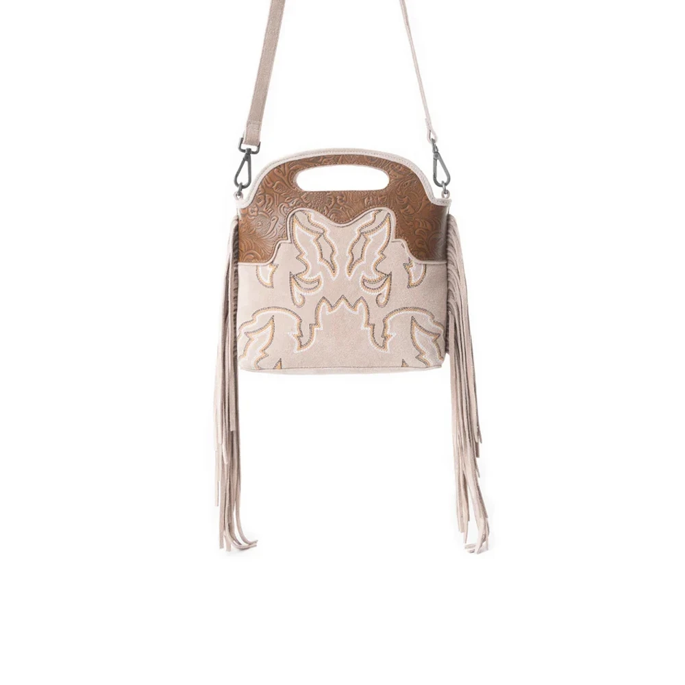 Electric Desert ivory and tan Western leather shoulder bag with embossed detailing, long fringe, cutout handle and adjustable crossbody strap.