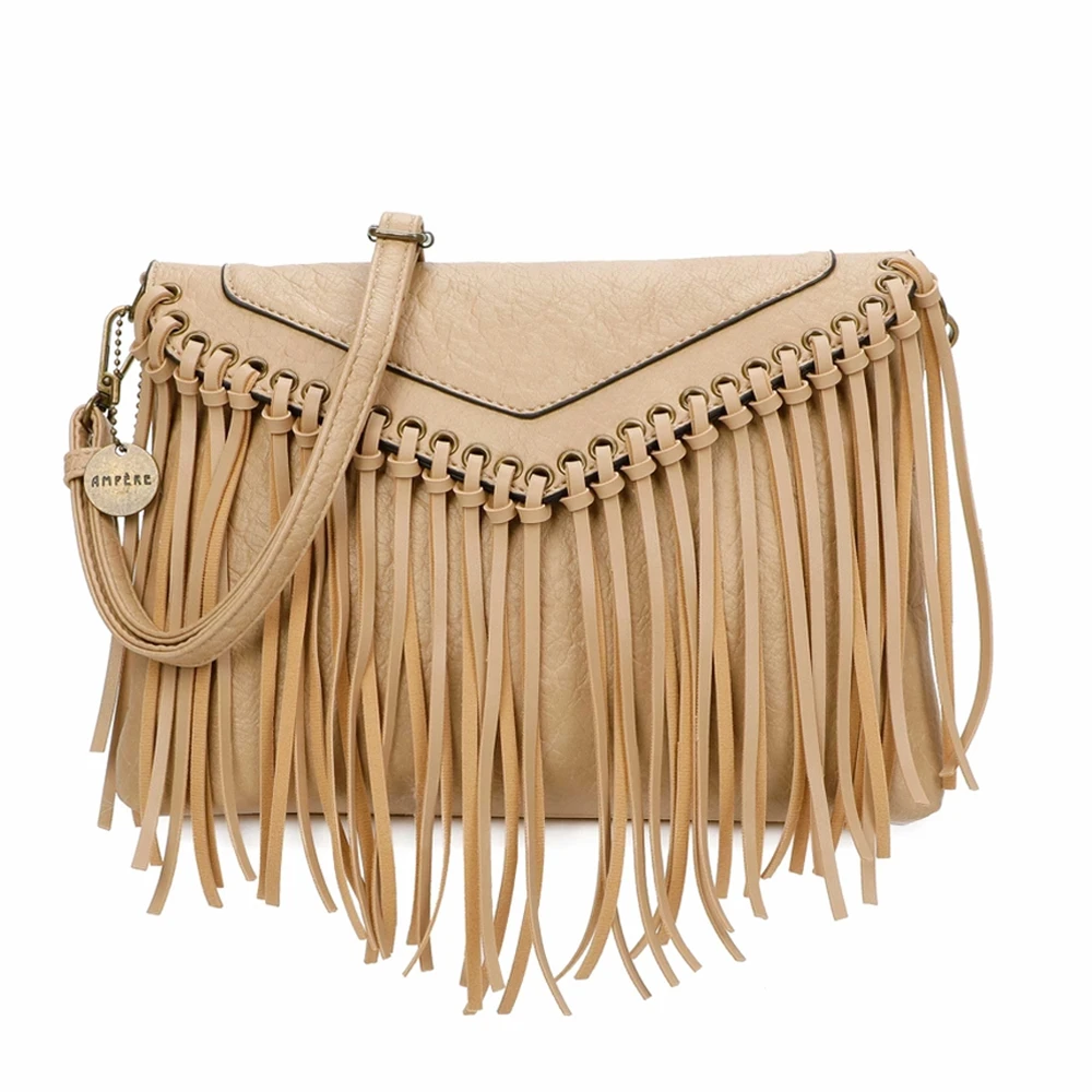 Ampere tan boho fringe crossbody purse featuring decorative metal grommets, woven trim, long fringe accents, textured leather-look material, and adjustable shoulder strap.