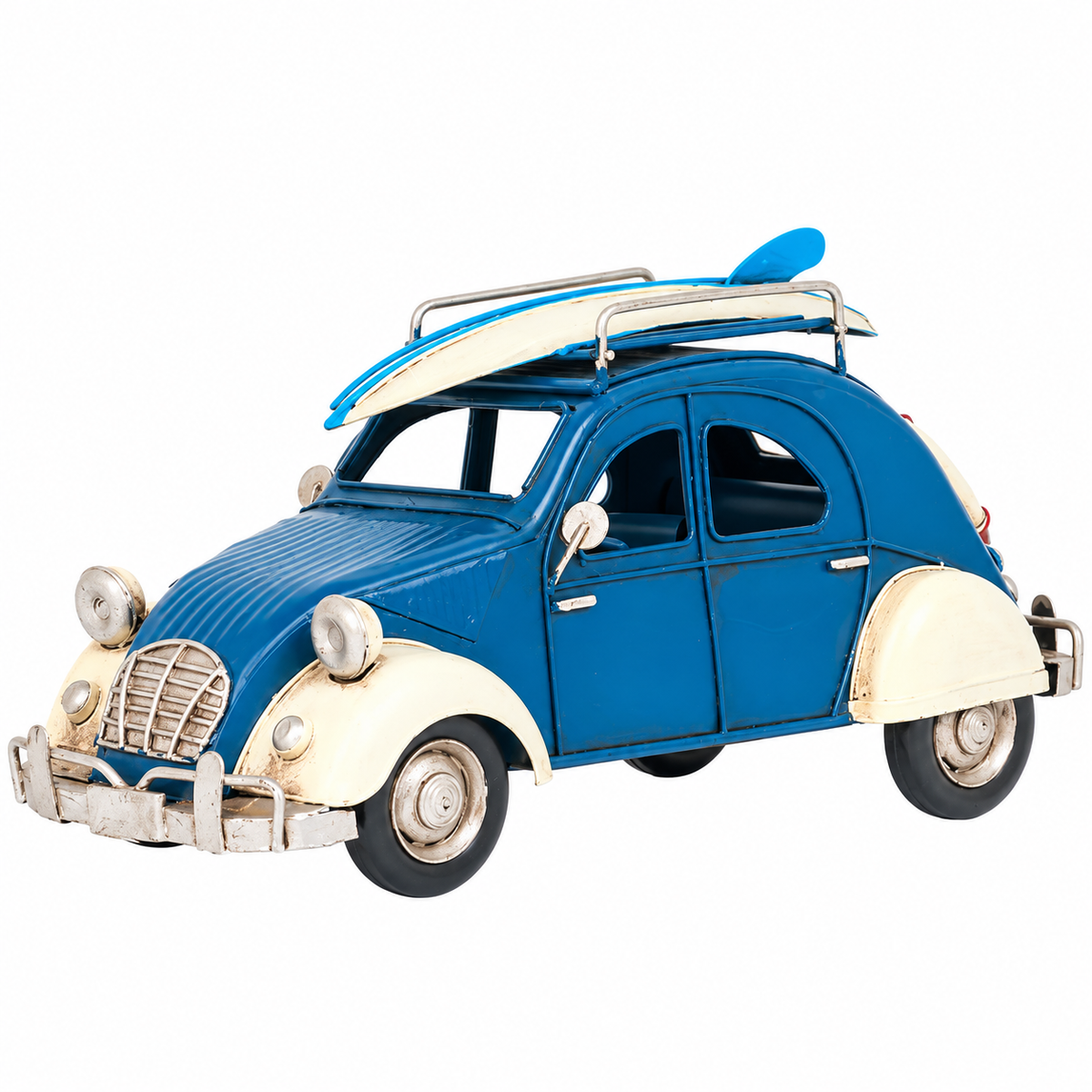 Vintage blue and cream Volkswagen Beetle-inspired metal decorative car featuring a blue and white surfboard on the roof rack, distressed detailing, silver-tone bumpers, and classic retro styling. Measures 10.2" long x 5" high.
