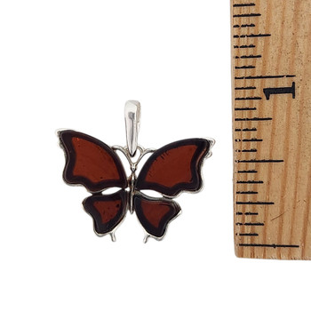 Cherry Amber butterfly sterling silver pendant with a ruler.  Cherry Amber butterfly sterling silver pendant with a ruler.