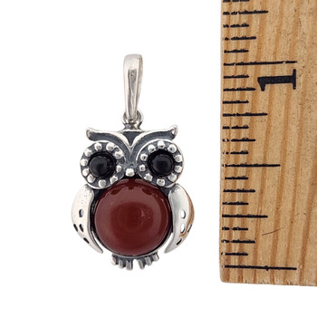 Cherry Amber owl sterling silver pendant with a ruler.  Cherry Amber owl sterling silver pendant with a ruler.
