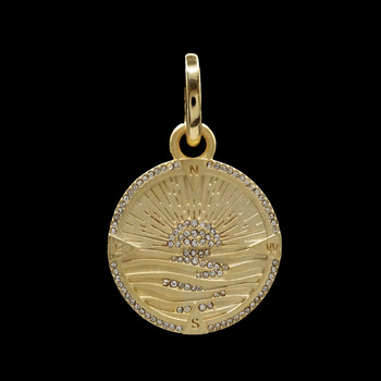 Sunrise compass gold-plate pendant with CZ stones on black background. Sunrise compass gold-plate pendant with CZ stones on black background.
