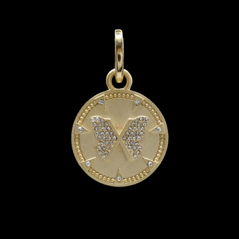 Gold-plated butterfly disc pendant with CZ stones on black background.  Gold-plated butterfly disc pendant with CZ stones on black background.