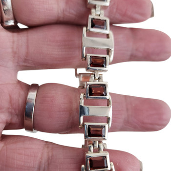 Red Garnet sterling silver bracelet in my hand. 