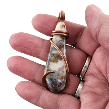 Large Ocean Jasper pendant with copper wire cold forge wrap in my hand. 