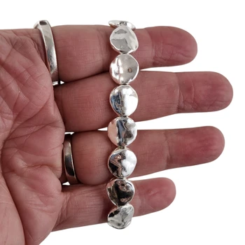 Round alloy beaded elastic bracelet in my hand. 