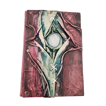 Handmade leather journal with a clear quartz stone nestled into leather. 