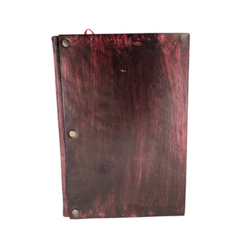 Handmade leather journal with a clear quartz stone nestled into leather,  backside view. 